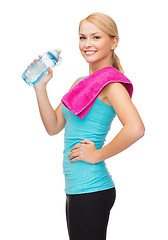 Image showing sporty woman with towel and watel bottle