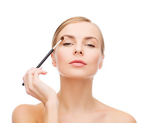 Image showing beautiful woman with makeup brush