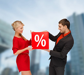 Image showing smiling woman and man with red percent sale sign