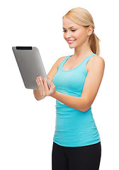 Image showing sporty woman with tablet pc