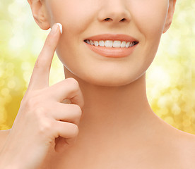 Image showing beautiful woman applying moisturizing cream