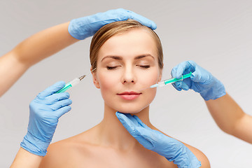 Image showing woman face and beautician hands with syringe