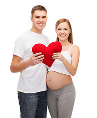 Image showing happy young family expecting child with big heart