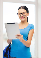 Image showing smiling female student with tablet pc and bag