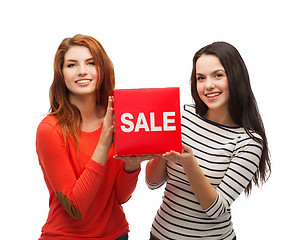 Image showing two smiling teenage girl with percent sign on box