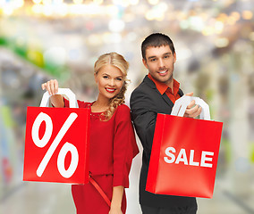 Image showing smiling man and woman with shopping bag