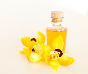 Image showing closeup of essential oil and orchid flowers