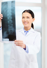 Image showing smiling young doctor in cabinet