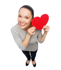 Image showing smiling asian woman with red heart