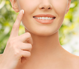 Image showing beautiful woman applying moisturizing cream