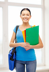 Image showing female student with folders and bag at school