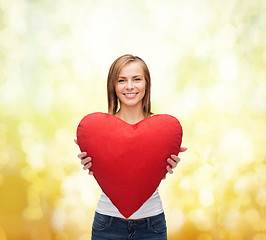 Image showing smiling woman in white t-shirt with heart