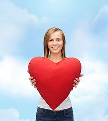 Image showing smiling woman in white t-shirt with heart