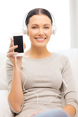 Image showing woman with smartphone and headphones at home