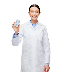 Image showing smiling female doctor with pills