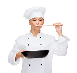 Image showing smiling female chef with pan and spoon