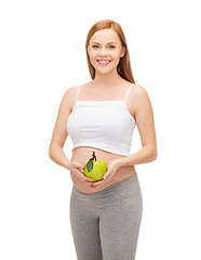 Image showing happy future mother with green apple