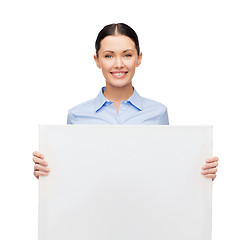 Image showing smiling businesswoman with white blank board