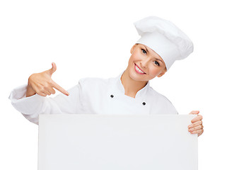 Image showing smiling female chef with white blank board