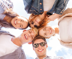 Image showing group of teenagers looking down