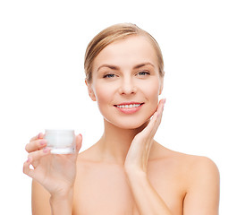 Image showing woman applying cream on her skin