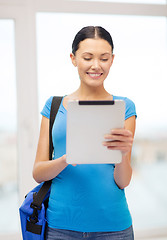 Image showing smiling female student with tablet pc and bag