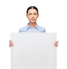 Image showing serious businesswoman with white blank board