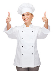 Image showing smiling female chef showing thumbs up