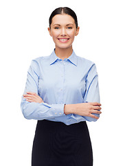 Image showing smiling businesswoman with crossed arms