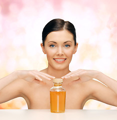 Image showing beautiful woman with oil bottle