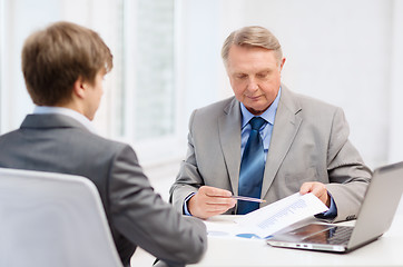 Image showing older man and young man having meeting in office