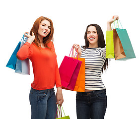 Image showing two smiling teenage girls with shopping bags