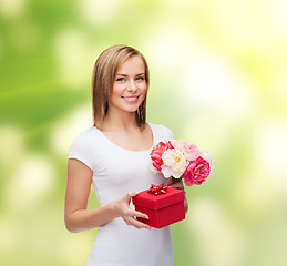 Image showing smiling woman with bouquet of flowers and gift box