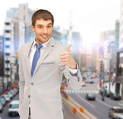 Image showing smiling businessman showing thumbs up