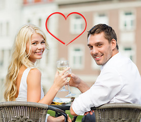 Image showing smiling couple drinking wine in cafe