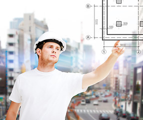 Image showing male architect pointing to blueprint