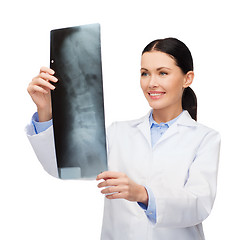 Image showing smiling female doctor looking at x-ray