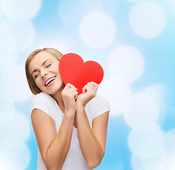 Image showing smiling woman in white t-shirt with heart