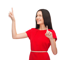 Image showing woman in red dress working with virtual screen