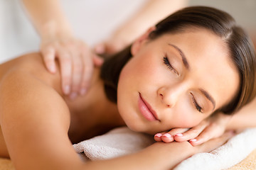 Image showing beautiful woman in spa salon getting massage