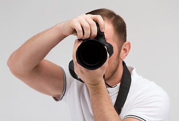 Image showing male photographer taking picture with camera