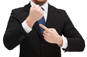 Image showing businessman pointing to something at his hand