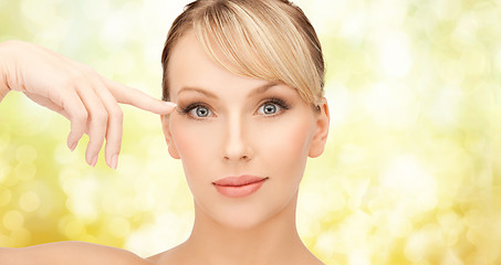 Image showing beautiful woman touching her eye area