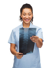 Image showing smiling female doctor or nurse looking at x-ray