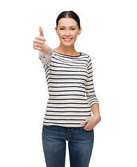 Image showing smiling girl in casual clother showing thumbs up