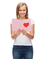 Image showing smiling girl with postcard