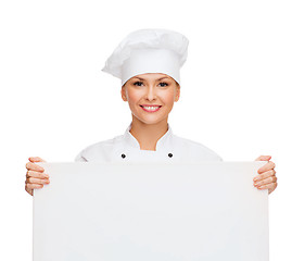 Image showing smiling female chef with white blank board