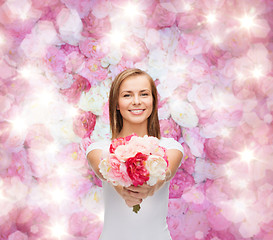 Image showing smiling woman with bouquet of flowers