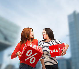 Image showing smiling teenage girl with percent and sale sign