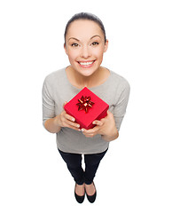 Image showing smiling asian woman with red gift box